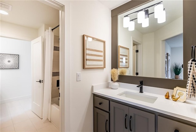 bathroom featuring tile patterned flooring, vanity, and shower / tub combo