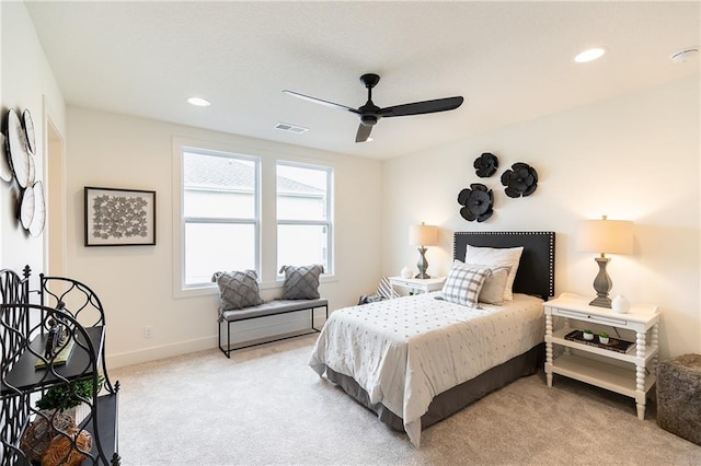 bedroom with ceiling fan and light carpet