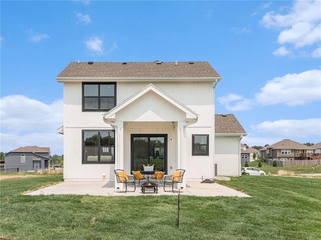 rear view of property featuring a patio area and a lawn