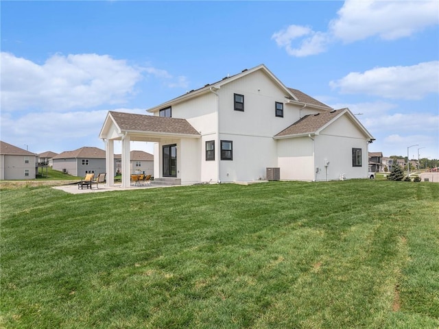 rear view of house with a yard, central AC, and a patio