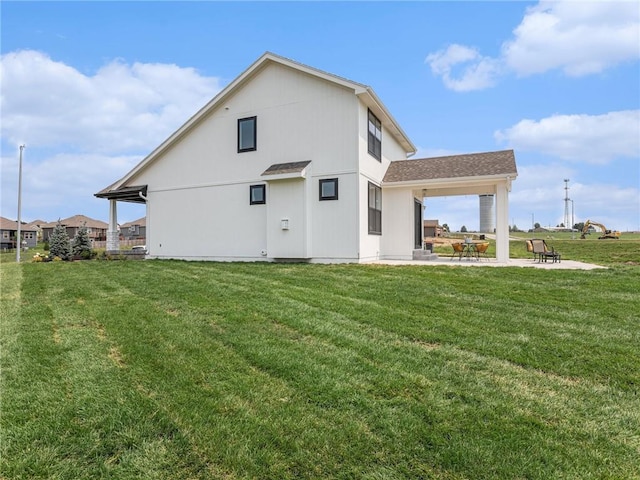 rear view of house with a patio area and a lawn