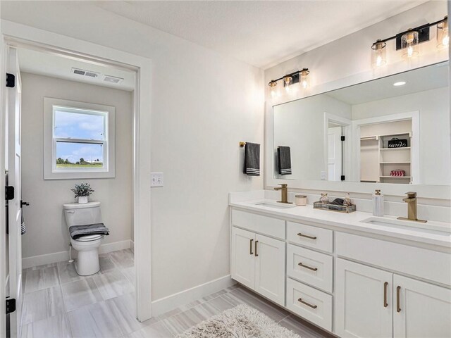 bathroom featuring toilet and vanity