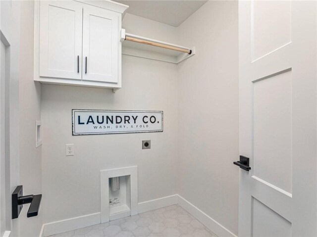 washroom with cabinets, light tile patterned flooring, hookup for a washing machine, and hookup for an electric dryer