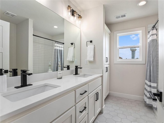 bathroom featuring vanity, tile patterned floors, and walk in shower