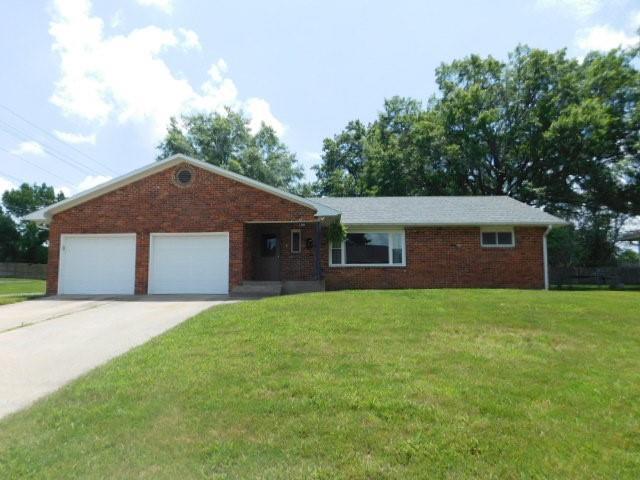 ranch-style home with a front yard and a garage