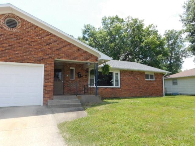 view of front facade with a front yard and a garage