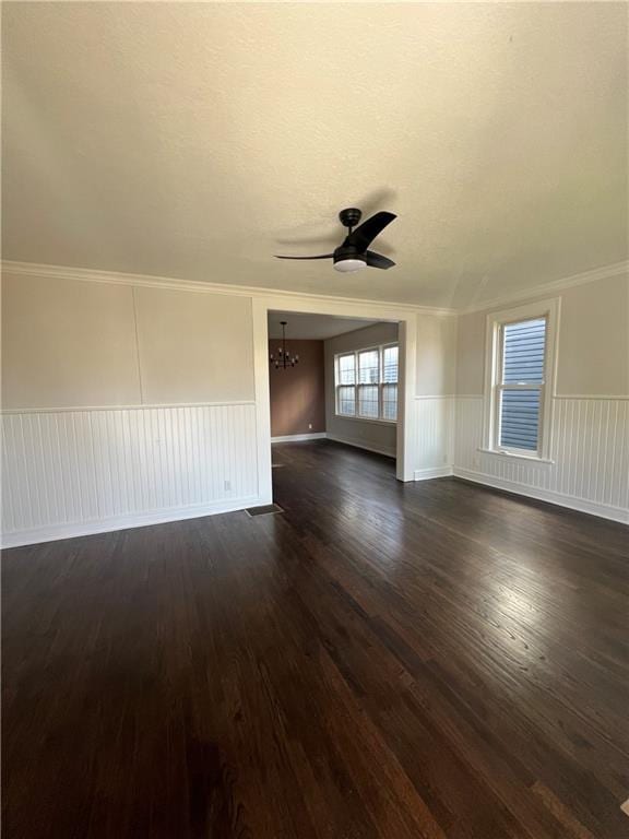 empty room with crown molding, ceiling fan, and dark hardwood / wood-style flooring