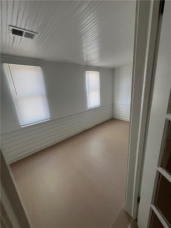 unfurnished room with wood-type flooring