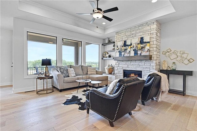 13028 S Constance St, Olathe, KS 66062 - living room featuring a tray ceiling, plenty of natural light, ceiling fan, light wood-style flooring, and ornamental molding