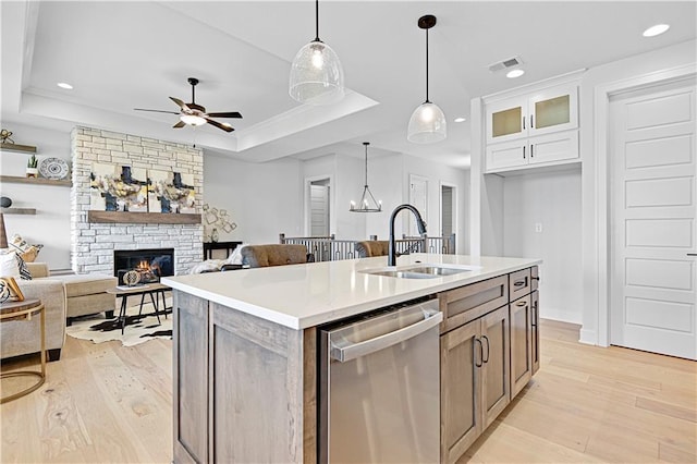 13028 S Constance St, Olathe, KS 66062 - kitchen featuring dishwasher, a tray ceiling, light wood finished floors, a ceiling fan, and pendant lighting
