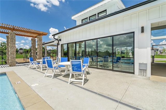 view of patio / terrace featuring a community pool and a pergola