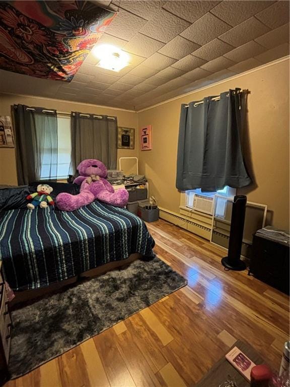 303 N Cayuga St, Frontenac, KS 66763 - bedroom featuring wood finished floors and cooling unit