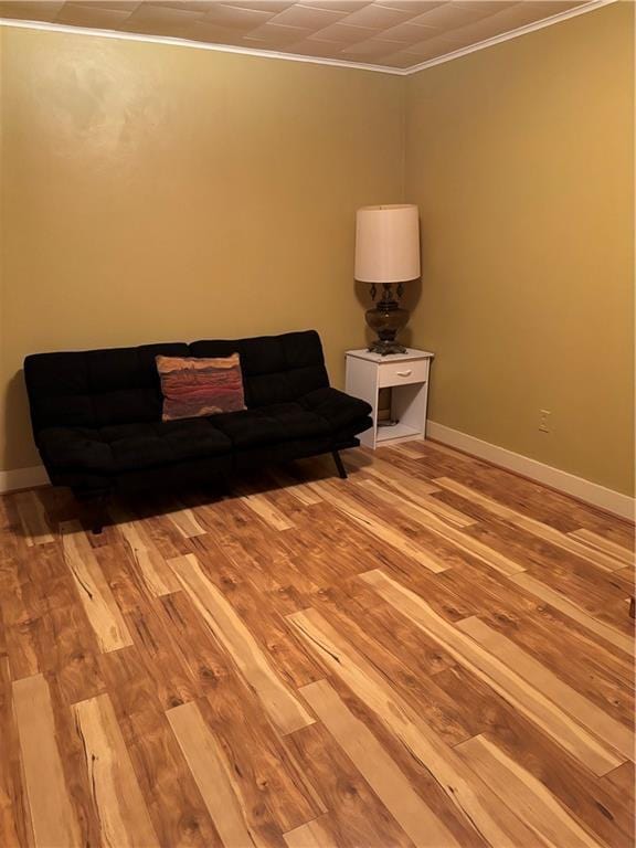 303 N Cayuga St, Frontenac, KS 66763 - living area with crown molding, light wood finished floors, and baseboards