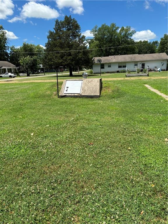 303 N Cayuga St, Frontenac, KS 66763 - view of storm shelter featuring a yard