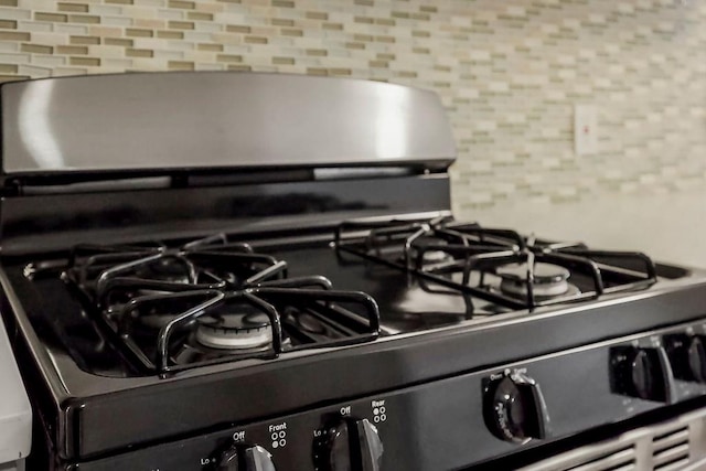 room details featuring stainless steel gas range and tasteful backsplash