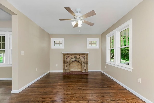 unfurnished living room featuring ceiling fan, a fireplace, and dark hardwood / wood-style flooring