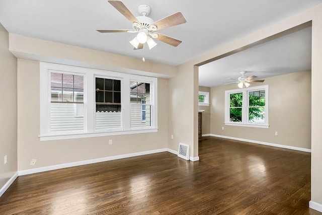 empty room featuring ceiling fan and dark wood-type flooring