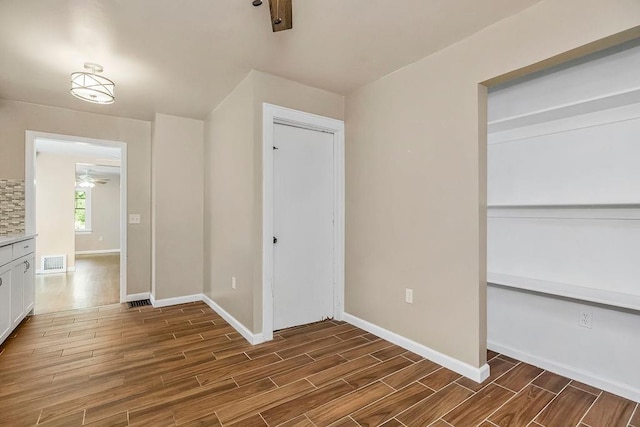 unfurnished bedroom with dark hardwood / wood-style flooring and a closet