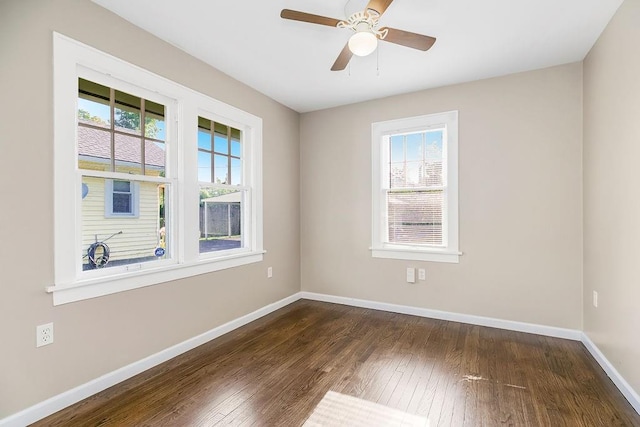 unfurnished room with ceiling fan, dark hardwood / wood-style floors, and a wealth of natural light