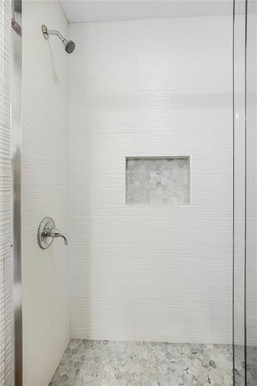 bathroom with tiled shower