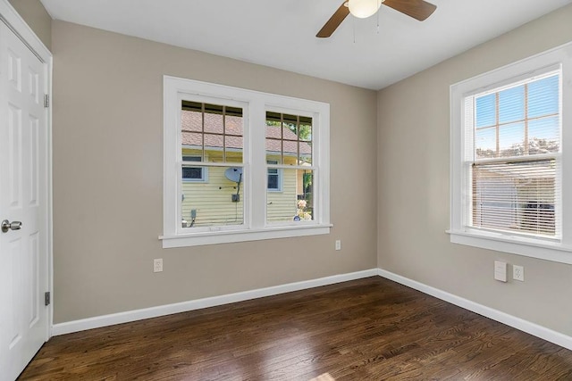 empty room featuring ceiling fan and dark wood-type flooring