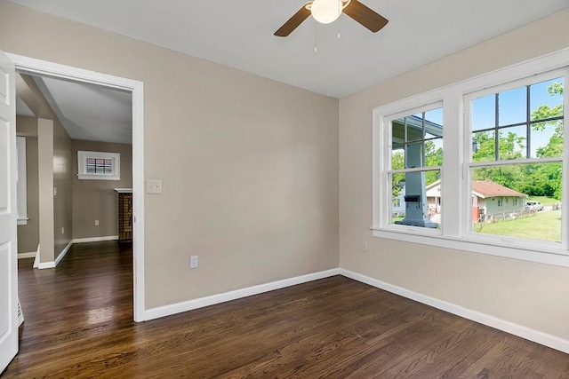 empty room featuring ceiling fan and dark hardwood / wood-style floors