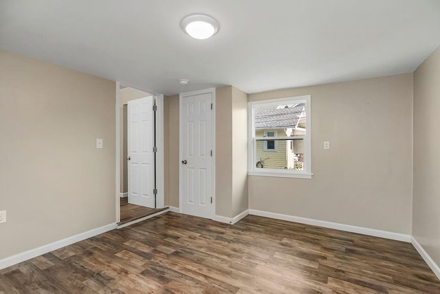 unfurnished room featuring dark hardwood / wood-style flooring