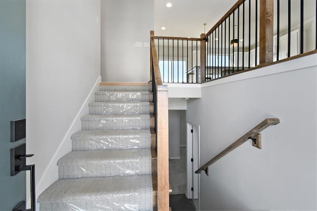 stairs featuring recessed lighting