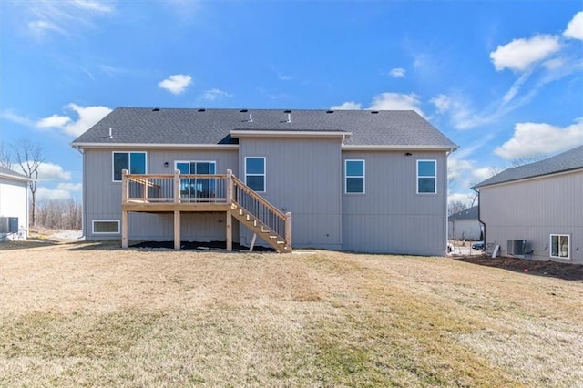 back of property with a lawn, roof with shingles, stairs, a wooden deck, and central air condition unit