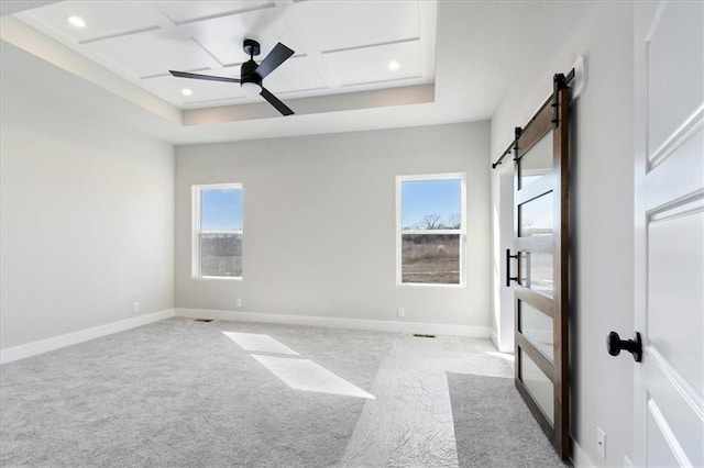 unfurnished bedroom with a barn door, baseboards, carpet flooring, and recessed lighting