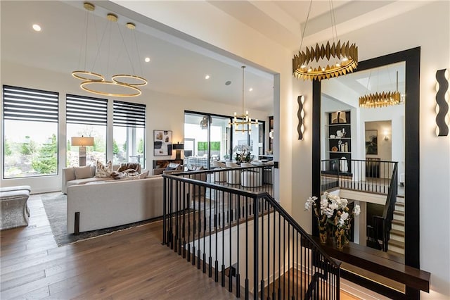 hall featuring hardwood / wood-style floors and a chandelier