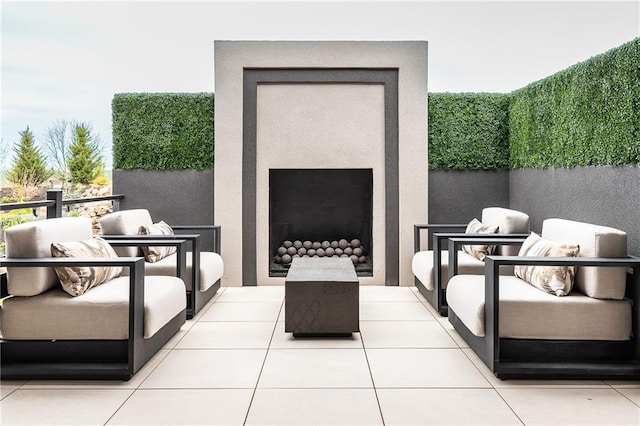 view of patio / terrace with an outdoor living space with a fireplace