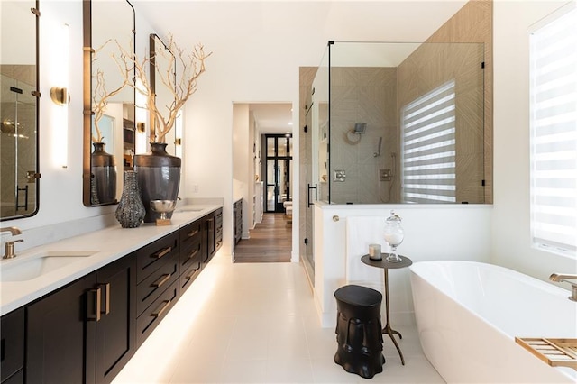 bathroom with plenty of natural light, shower with separate bathtub, tile patterned flooring, and vanity