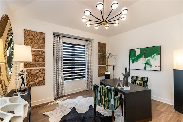 office area with a notable chandelier and hardwood / wood-style flooring