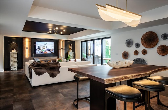 dining room with french doors and a tray ceiling