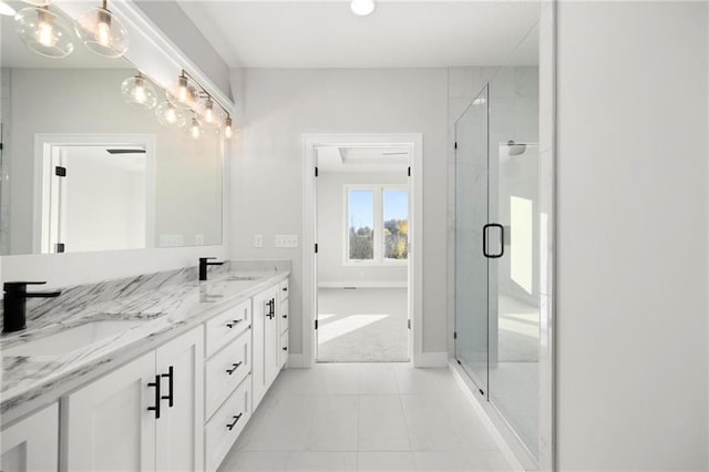 bathroom with tile patterned floors, vanity, and walk in shower