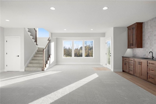 interior space featuring light carpet and sink