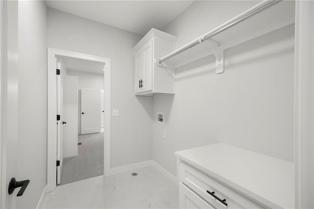 laundry area featuring washer hookup and cabinets