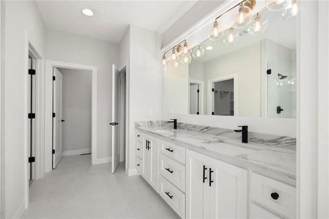 bathroom with concrete flooring, vanity, and an enclosed shower