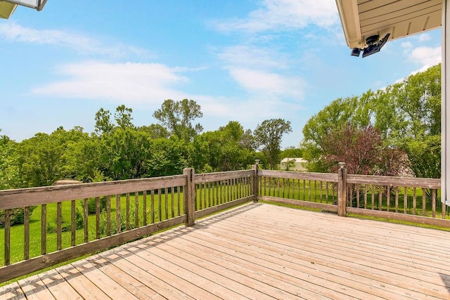 wooden terrace with a lawn