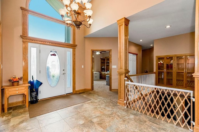 foyer entrance featuring a chandelier and ornate columns