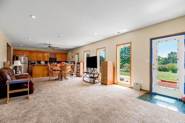 living room with light carpet and ceiling fan