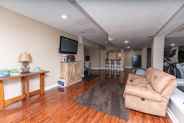 living room with hardwood / wood-style floors and bar area