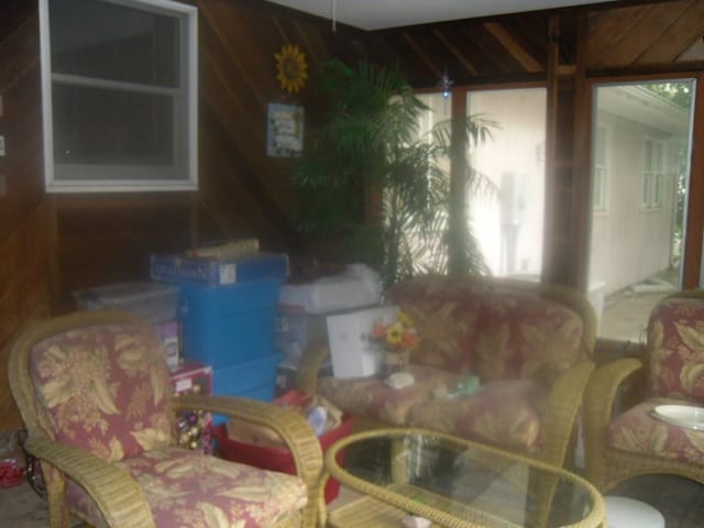 living room featuring wood walls