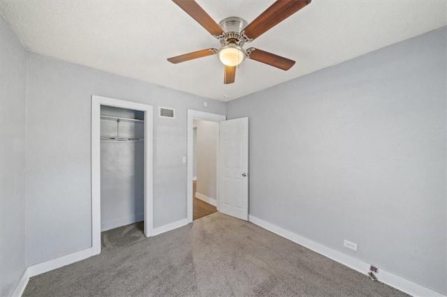 unfurnished bedroom featuring light carpet, a closet, and ceiling fan