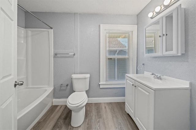 full bathroom featuring toilet, vanity, hardwood / wood-style floors, and shower / bathing tub combination