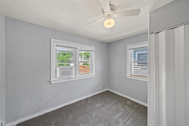 empty room featuring ceiling fan, cooling unit, a textured ceiling, and carpet flooring