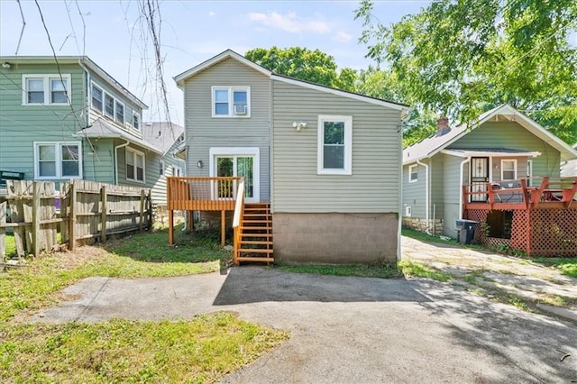 back of property featuring a wooden deck