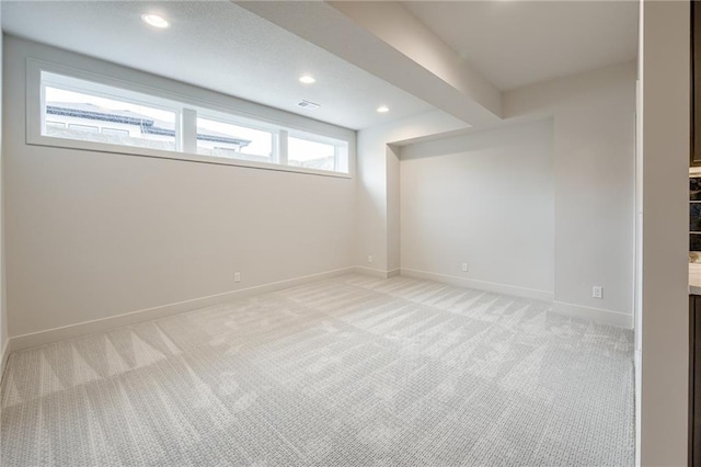 unfurnished room featuring visible vents, baseboards, light colored carpet, beam ceiling, and recessed lighting