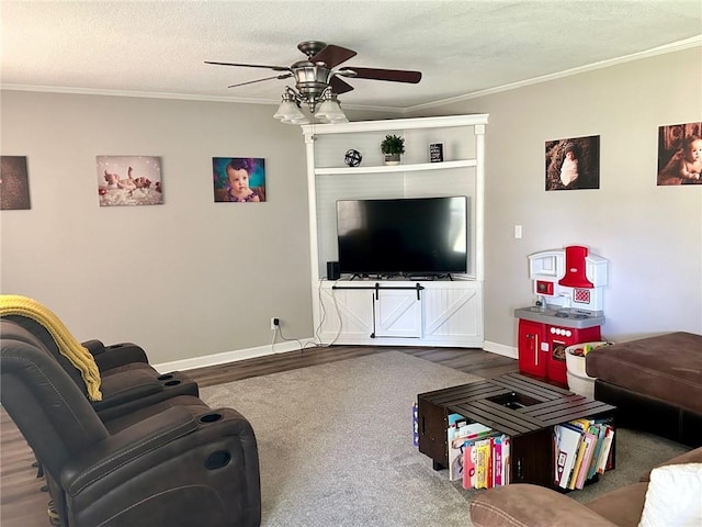 living room featuring crown molding, ceiling fan, wood-type flooring, and a textured ceiling